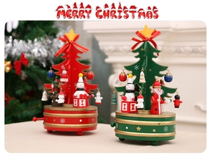 Close-up of wooden Christmas tree music box with miniature Santa and angel ornaments