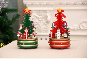 Macro detail of wooden Christmas tree music box with festive Santa and snowman figures