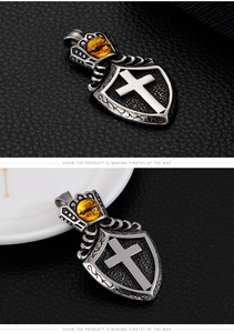 Detailed close-up of retro stainless steel shield pendant with yellow evil eye and cross