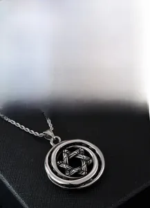 Detail view of vintage hexagram star pendant in silver stainless steel with twisted chain