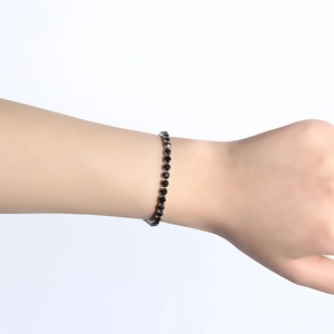 Close-up of a silver titanium steel tennis bracelet featuring black cubic zirconia stones