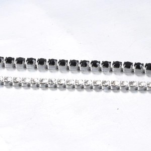 Macro shot of black and clear 3mm cubic zirconia tennis chains with silver steel settings