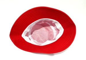 Detail shot of the red cotton bucket hat interior with white lining and reinforced stitching