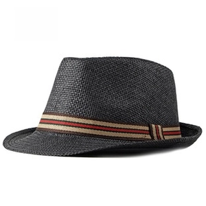 Detailed view of black paper straw fedora with vintage red and green striped band decor