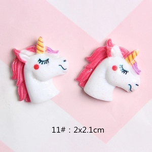 Detail of glitter resin unicorn charms with pink mane for DIY hair clips and shoes