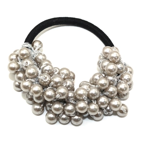 Handmade woven hair tie with dark grey faux pearls and black elastic band on white background