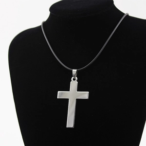 Minimalist stainless steel cross pendant necklace displayed on a black velvet mannequin