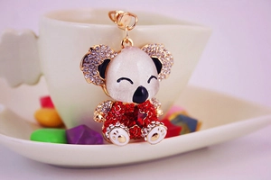 Close-up of golden koala keychain with sparkling crystals and red star gem detail