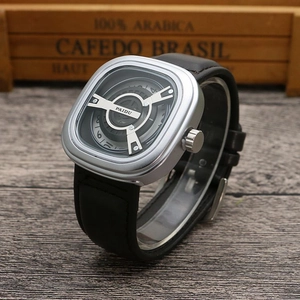 Detail of square silver quartz watch with black leather strap on a vintage wood background