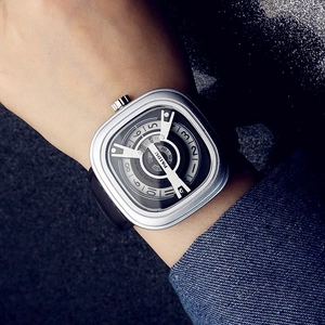 Close-up of PAIDU square turntable watch with silver case and black leather strap on wrist