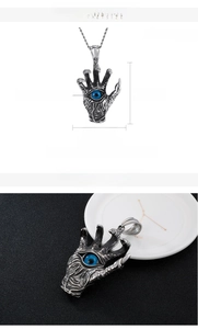 Macro shot of gothic dragon claw pendant with blue cat eye stone and size specifications