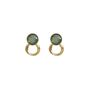 Vintage gold earrings with green textured circles in a minimalist retro style design