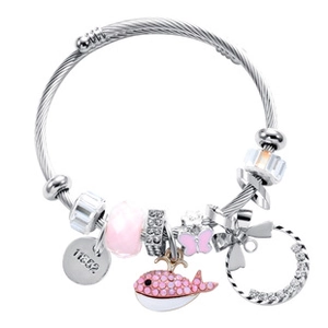 Close-up of steel wire bracelet with pink whale charm, butterfly, and beaded pendants