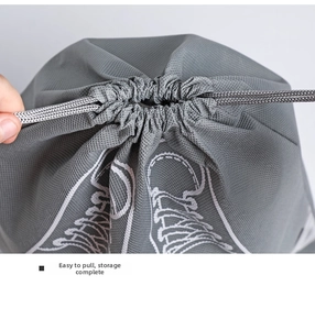 Detail of grey non-woven drawstring shoe bag showing easy pull closure mechanism
