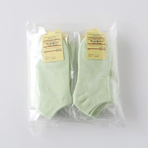 Detail of light green cotton blend low-cut socks in clear OPP gift bag packaging