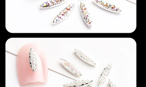 Detail of leaf-shaped alloy nail charms with AB rhinestones and white pearls for DIY manicure