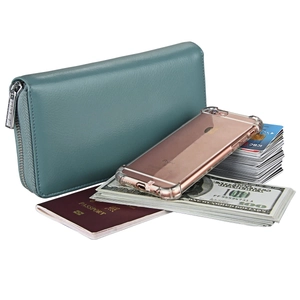 Macro view of leather passport wallet capacity showing phone, cards, and banknotes