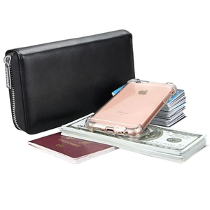 Detailed view of leather wallet interior holding a passport, smartphone, and cards