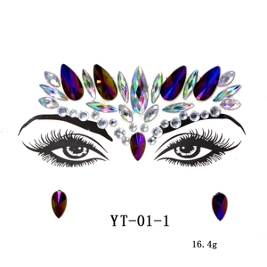 Detailed view of acrylic face jewels with purple drop stones and iridescent eye gems