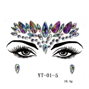 Detailed placement of iridescent facial gemstone stickers with teardrop and circular gems
