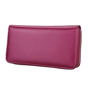Close-up of fuchsia leather wallet featuring textured lychee grain and silver zipper detail