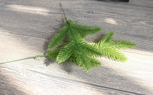 Close-up of green artificial pine needle branches for DIY Christmas tree ornaments