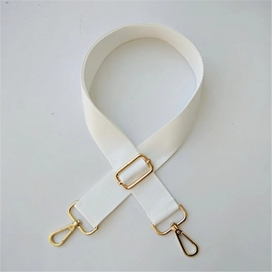 Adjustable white woven bag strap detail with golden metal hooks and slide buckle