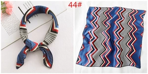50x50cm silk scarf with red and blue geometric patterns shown tied and flat on white