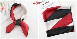 Detail view of contrast geometric pattern silk scarf with premium stitched edges