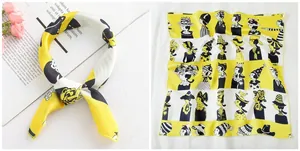 Detail of yellow silk scarf with cartoon print on a magazine next to pink flowers