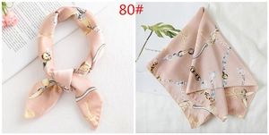 Detail of light pink satin scarf with gold chain and pearl print patterns