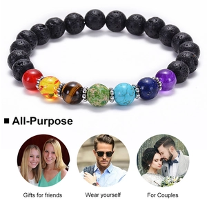 Macro shot showing seven chakra energy beads and textured black lava stone on elastic cord