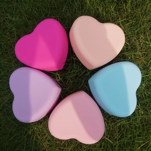 Macro shot of heart-shaped silicone makeup brush cleaners in five assorted pastel colors