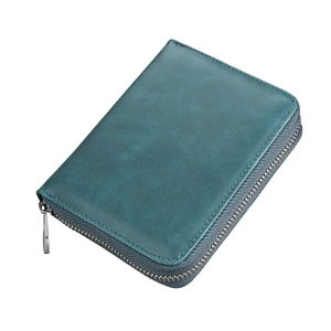 Detail of teal leather card holder featuring high-quality metal zipper and hand-stitched seams