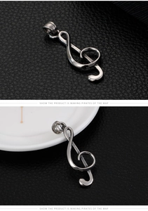 Detailed view of silver G-clef pendant with vintage finish and sturdy metallic texture
