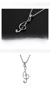 Detailed view of stainless steel treble clef pendant with 37x15mm dimensions and 3g weight