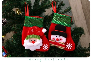 Detail of Christmas stockings with Santa and Snowman hanging on a decorated tree