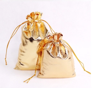 Detailed view of dual-size golden drawstring gift bags with metallic texture and sheen
