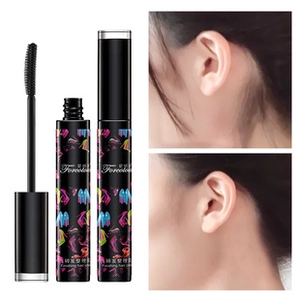 Macro detail of finishing hair stick brush head and bottle for taming flyaway hair