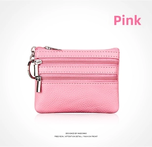 Pink pebbled leather coin purse with three zip compartments and a metal keychain ring