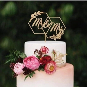 Macro detail of Mr & Mrs wooden wedding cake topper with elegant geometric hexagon design