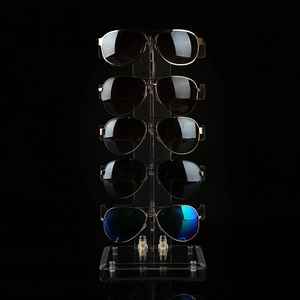 Five-tier desktop sunglasses display rack in frosted plastic on professional black background