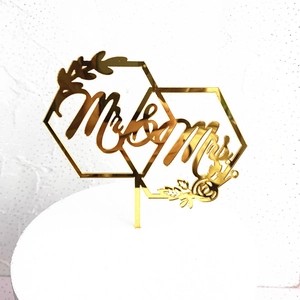 Detail of golden mirror acrylic Mr & Mrs geometric hexagon cake topper for wedding decor