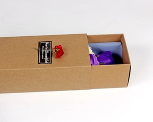 Detail view of craft paper gift box with purple soap roses and nature gift label