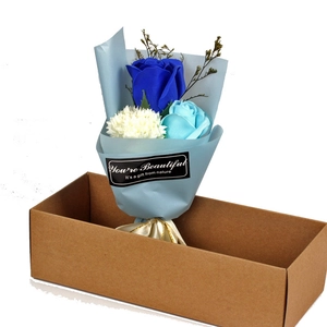 Detail of blue soap flower bouquet with carnation and rose in a brown gift box