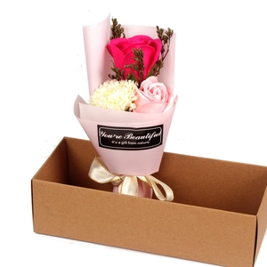 Detailed gift box with soap roses and carnations wrapped in pink paper and champagne ribbon