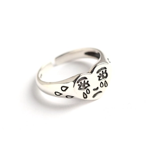 S925 sterling silver heart-shaped ring with unique crying face engraving on white surface