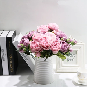 Pink and purple faux peonies in a white ribbed ceramic vase for home decor