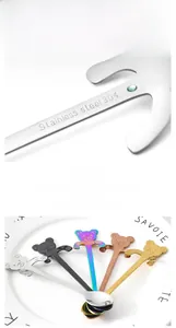 Detail of 304 stainless steel cartoon bear spoons hanging on a cup edge in five colors