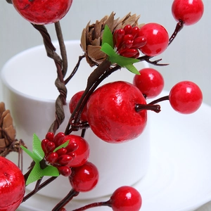 Christmas wreath with red berries and pine cones for festive home door and window decoration